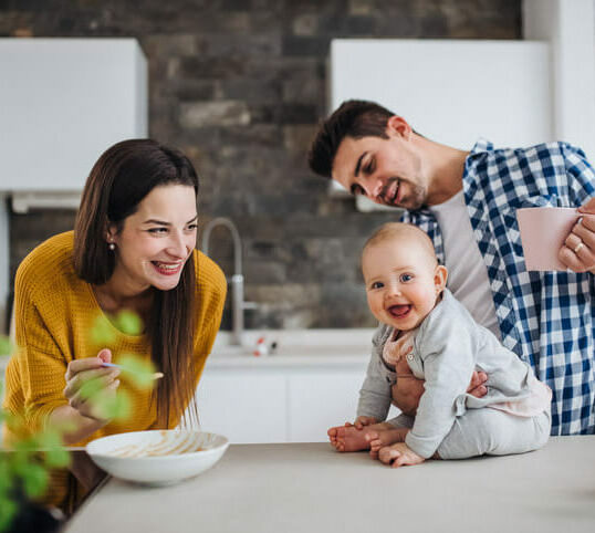 parents and baby in kitchen